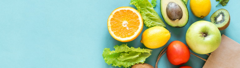 healthy fruits and vegetables on a blue background