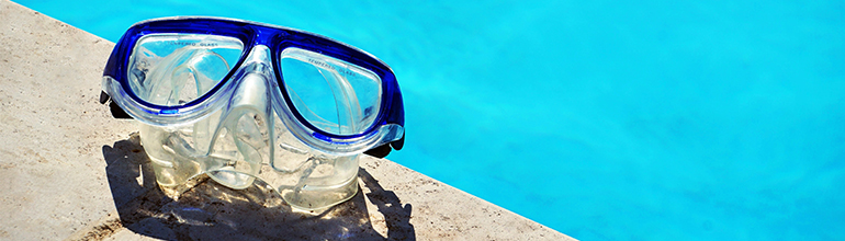 goggles next to a swimming pool