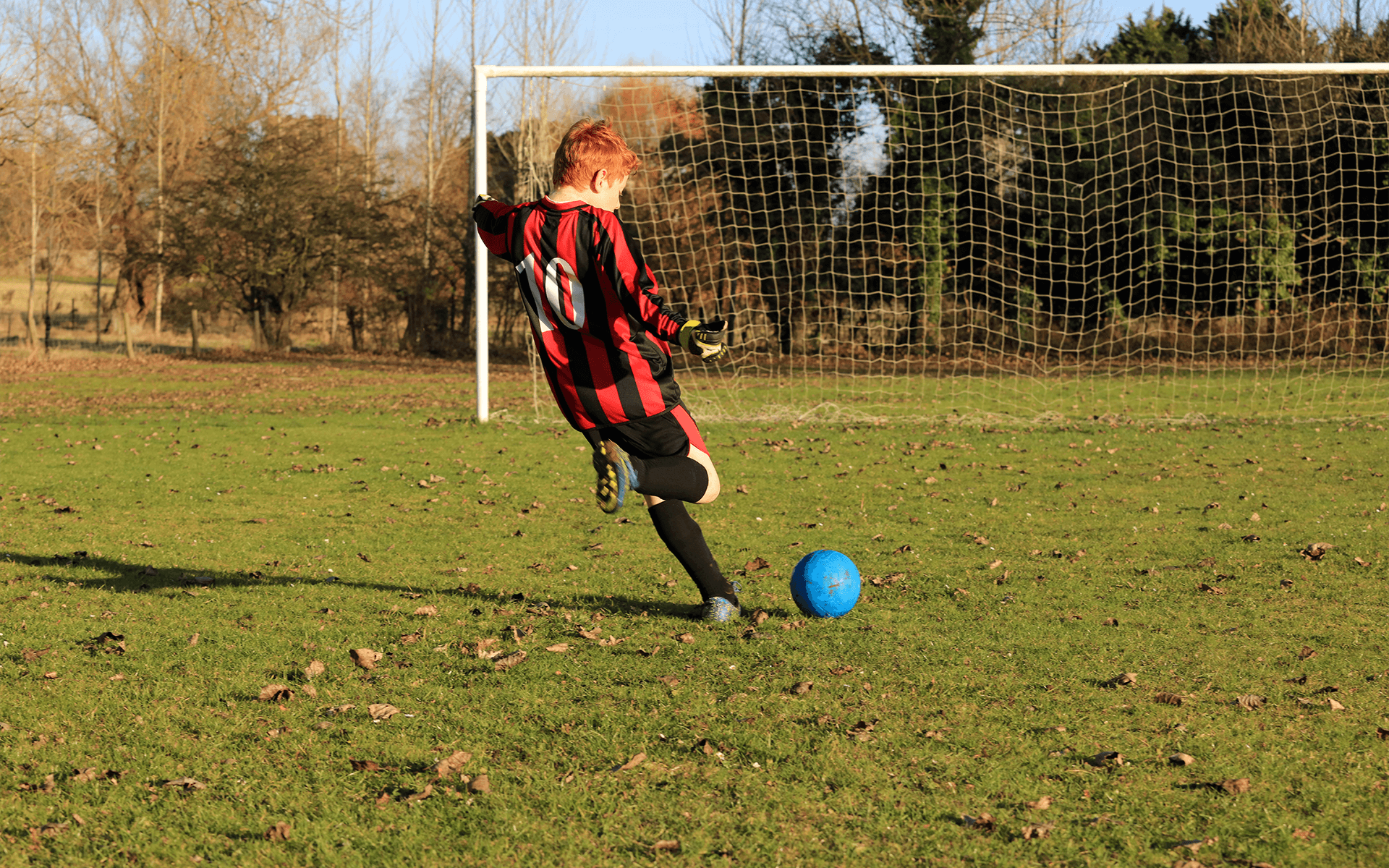 Boy playing football normal vision