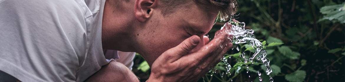 Man washing his face with water