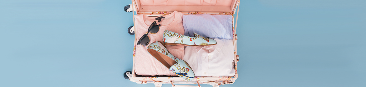 Open suitcase with clothes and shoes
