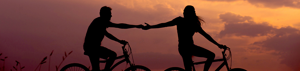 Silhouette of couple cycling