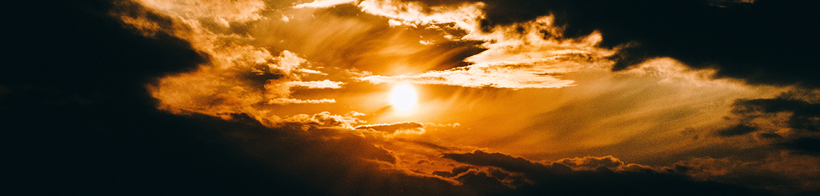 Sun shining through breaking clouds