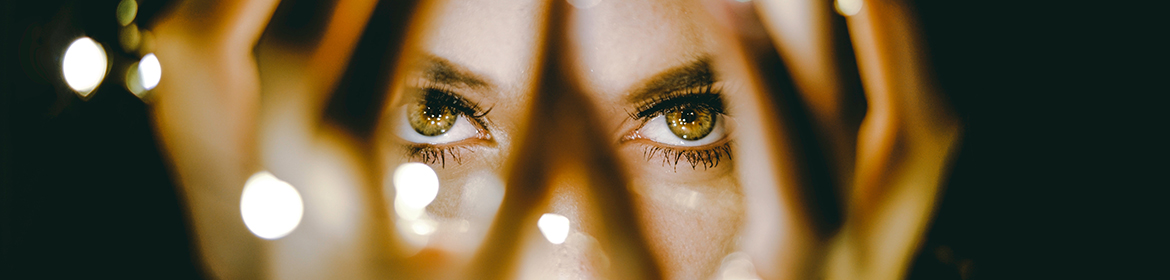 Woman looking through her hands