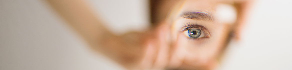 Woman's eye through a glasses lens