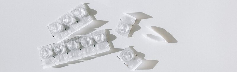 Contact lens blister packs on white surface