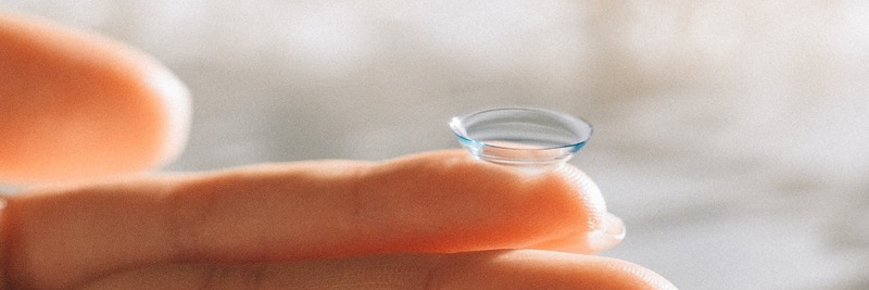 Contact lens balanced on pointer finger