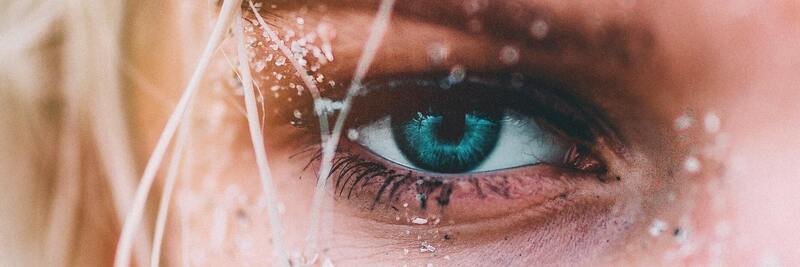 Close up of eye, sand on the skin around the eye