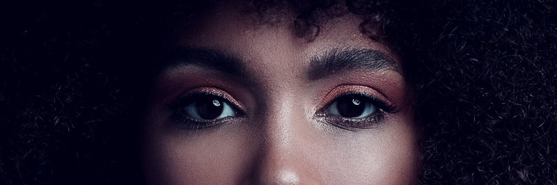black woman facing the camera, focus on her eyes