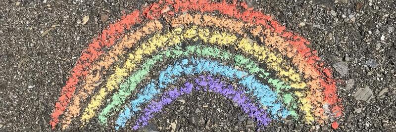 chalk drawing of a rainbow on asphalt