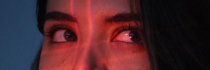 Eyes of a woman in red light