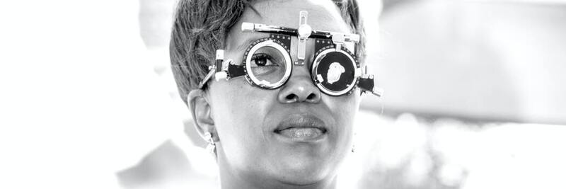 Photo of a woman looking through optometry tool