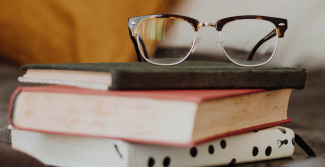 Glasses on top of books