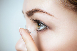 woman inserting contact lenses