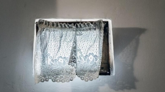window with white lace curtains
