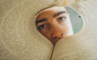 man-looking-through-pages-of-a-book-eyes