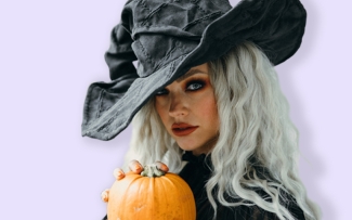 Woman in witch hat and coloured contact lenses for Halloween