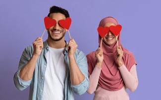 couple with hearts over their eyes with a purple background