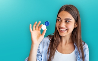 Woman holding and looking at a contact lens case 