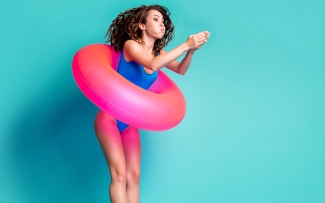 woman with innertube pretend diving into pool