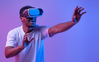 man with virtual reality headset on purple background