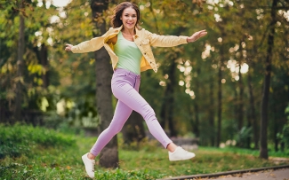 woman outdoors excited jumping