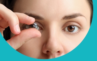 woman holding a lens up to her eye