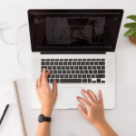 Student typing on Apple Mac