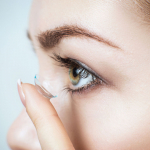 Woman inserting contact lens